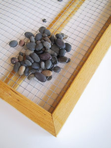 4. Smooth the wire and, if necessary, secure it to the cross supports with construction staples. Add the stones; 10 pounds of river or beach pebbles should do it.